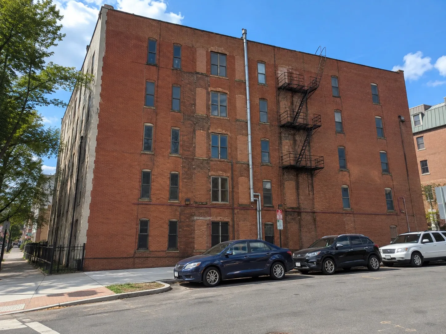 Large red brick building in Washington DC with patched brickwork and infilled window openings