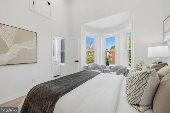 Primary suite with a 12-foot ceiling and a curved bay window in the Shaw rowhome