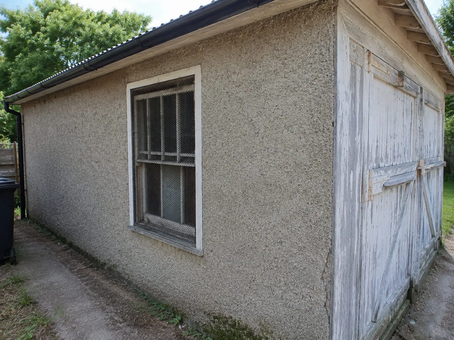 Textured stucco finish covering the exterior walls of a Washington DC outbuilding
