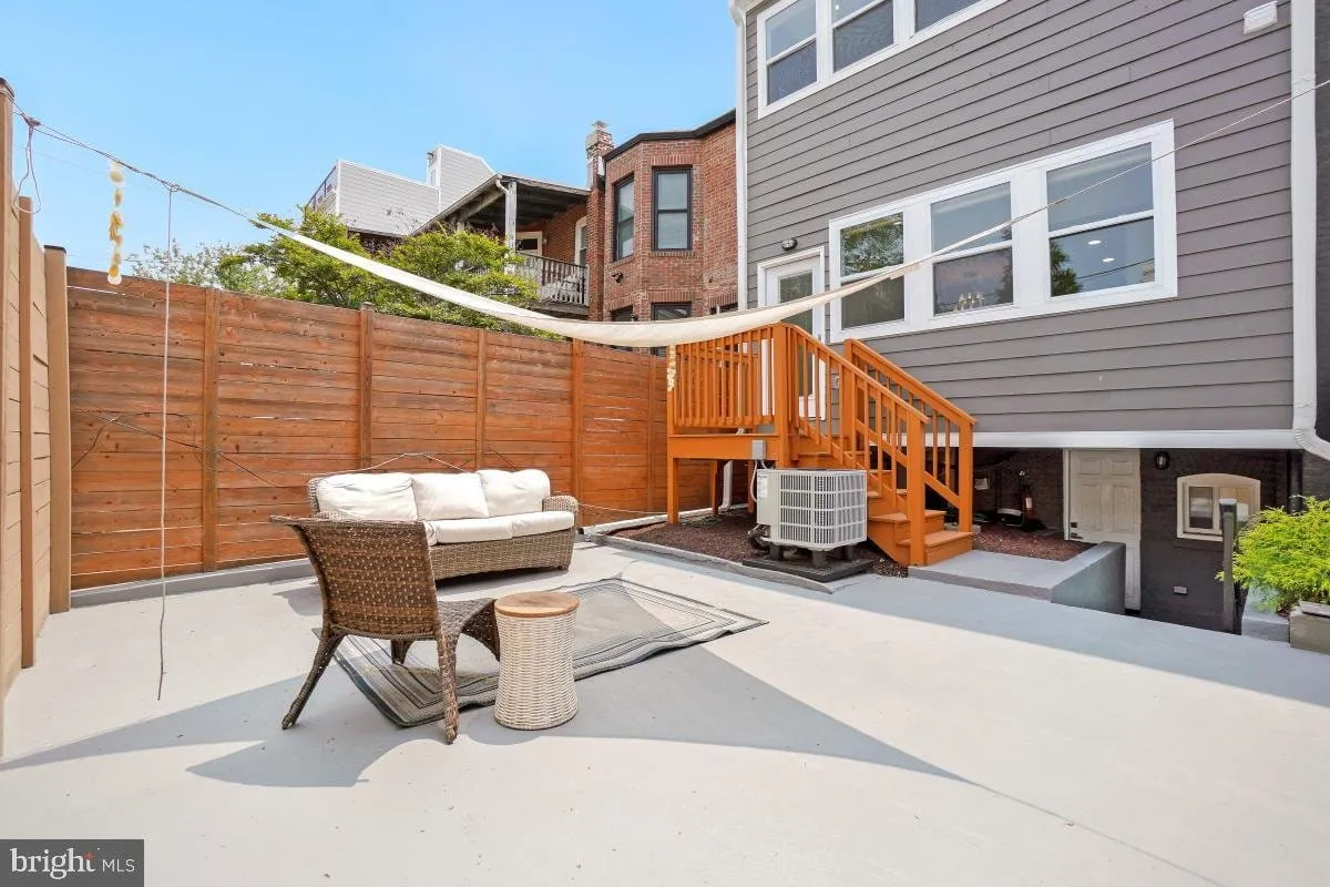 Rebuilt rear patio with a privacy fence, shade sail and new timber stairs to the upper deck